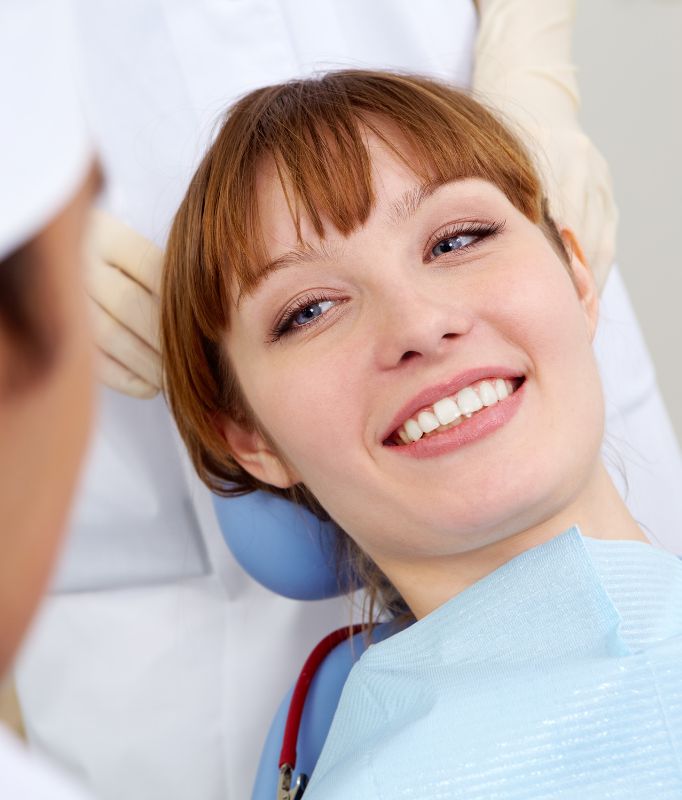 Dental check-up Kilburn. Woman sitting in a dentist's chair. she is smiling