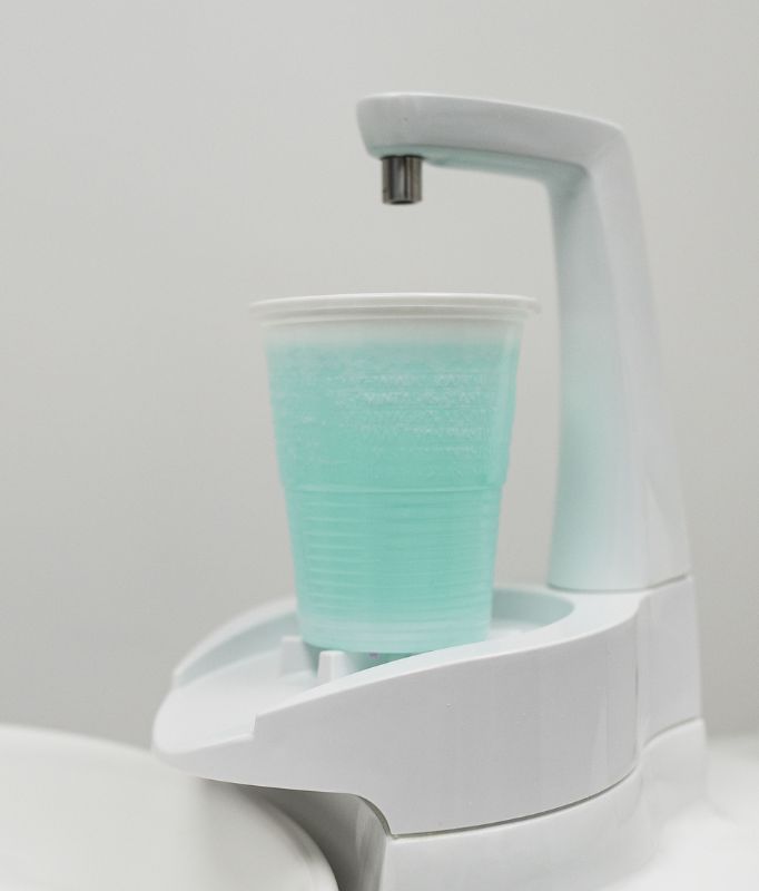 Image of cup besides dental chair. General dentistry by Shape Dental.